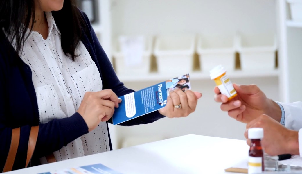 Woman buying medication in a pharmacy